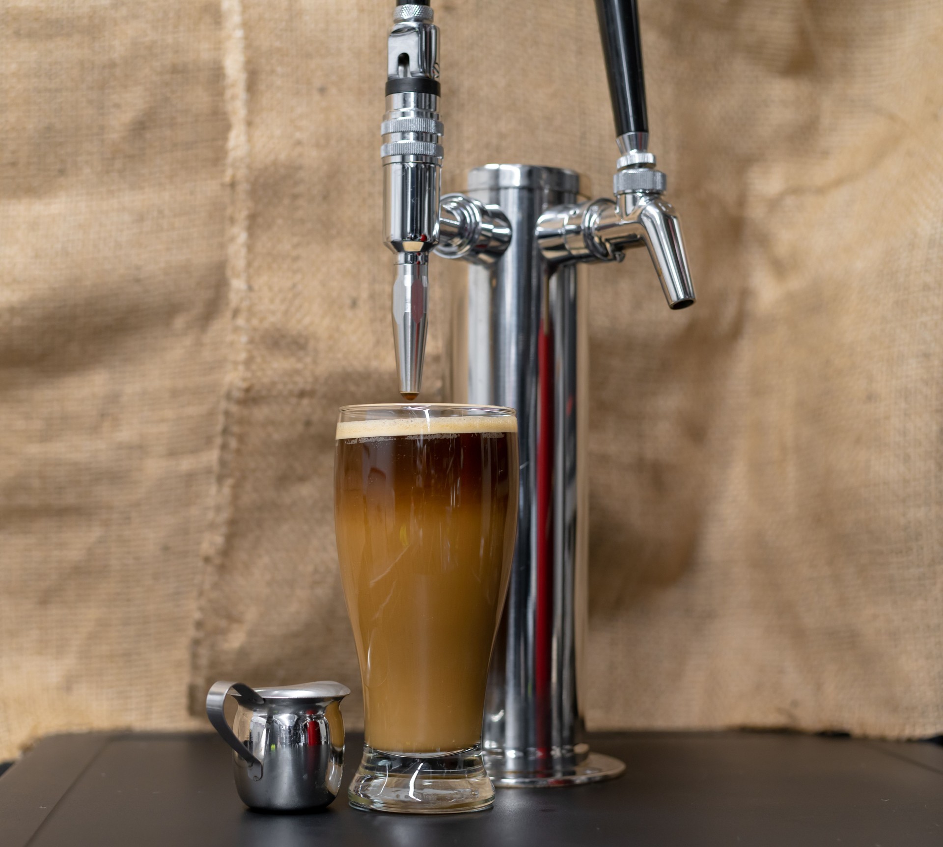 Nitro Cold brew coffee next to a beer style dispensing Tap.